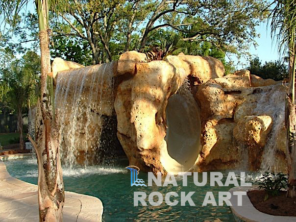 Coral rock, waterfall and slide using simulated rock.