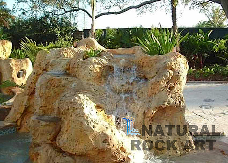 Coral rock and small waterfall using simulated rock.
