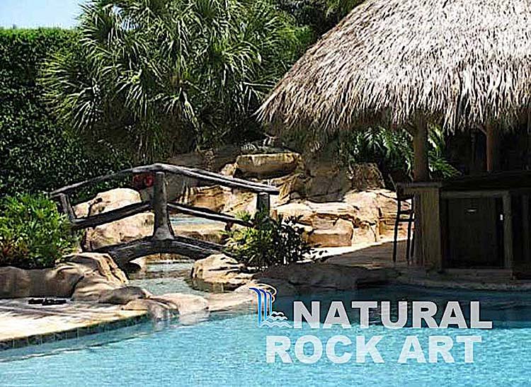 Island theme pool with stream crossing using simulated rock.